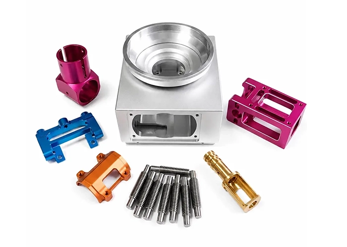 Precision CNC machining process displaying color-anodized multi-axis milled housing components, turned brass pins, concentric steel threads, and complex aluminum blocks representing high-precision contract manufacturing capabilities.