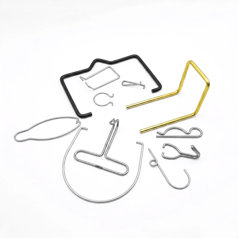 Custom precision-formed wire components fabricated by FIWOK, including stainless steel spring clips, a yellow-passivated bent support wire, black-coated frames, and custom steel retaining hooks.
