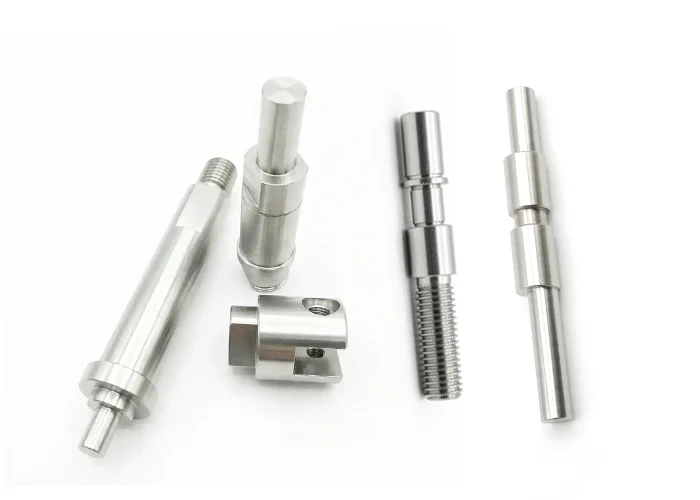 Custom CNC machined shafts and axles with controlled diameters, shoulders, and grooves by FIWOK METALWORKS.