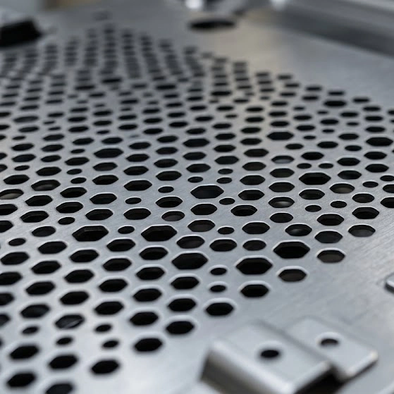 CNC turret punching and progressive die metal stamping process for high-speed, scalable sheet metal fabrication.
