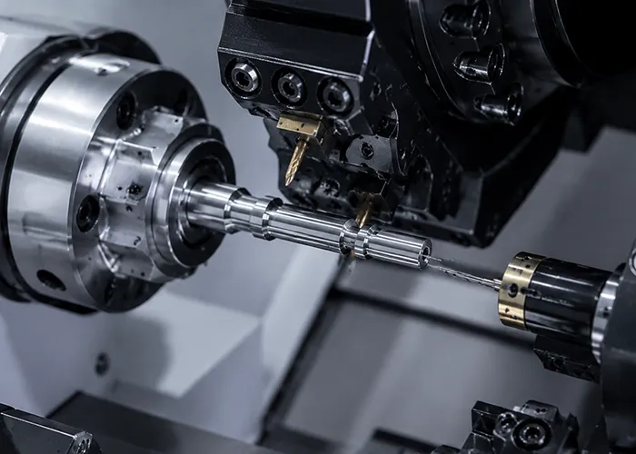 Swiss-type CNC machining of a small-diameter metal component with live tooling at FIWOK.