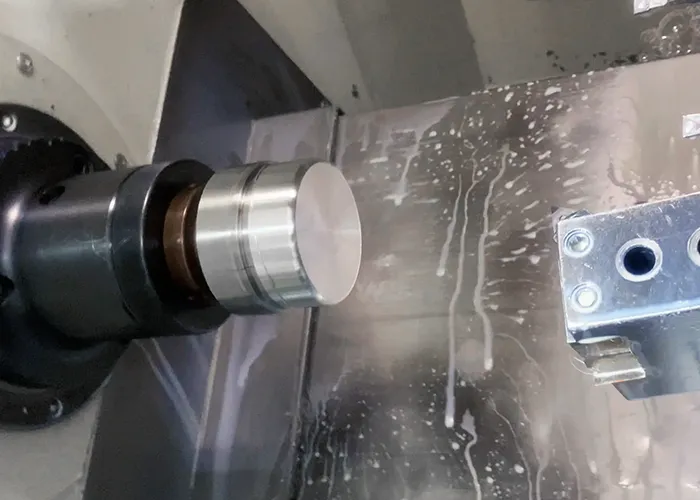 CNC turning of a cylindrical steel shaft at FIWOK.