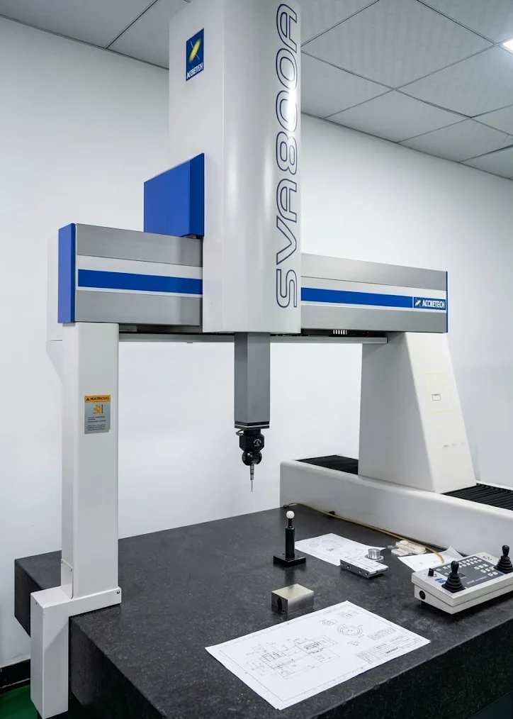 CMM coordinate measuring machine setup with drawing review for critical geometric tolerance verification on precision parts.